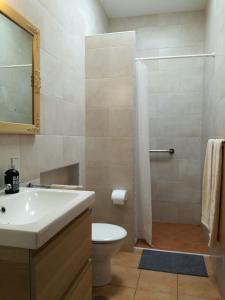 a bathroom with a toilet and a sink and a shower at Casa Jasmin Haria in Haría