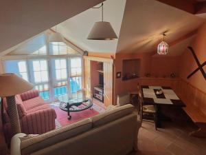a living room with a couch and a table at Plaza Andalucía Edificio Enebro 4-6 pax in Sierra Nevada
