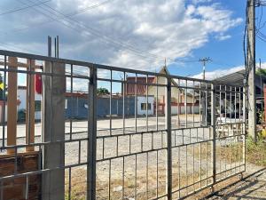 a metal fence in front of a train yard at Stay Like a Local เต็นท์บ้านเรา in Chiang Mai