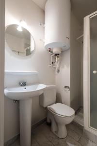 a bathroom with a toilet and a sink and a mirror at Ground floor sea view Raversijde Lets Go Getaways in Ostend +8 photos