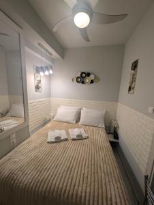 una camera da letto con un letto grande con due asciugamani sopra di EV Apartment with free parking place a Volos