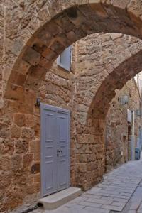 Un edificio de piedra con una puerta azul. en Akotika boutique, en Acre