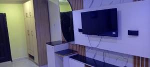 a living room with a tv on a wall at 517 VIP suites and apartments in Awka