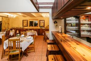 a restaurant with tables and chairs and a bar at Beaufort Manor Country Lodge in Beaufort West