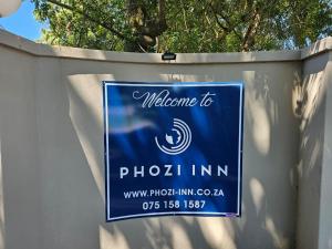 a sign on a wall that reads welcome to phximm at Phozi Inn in Eshowe +13 photos