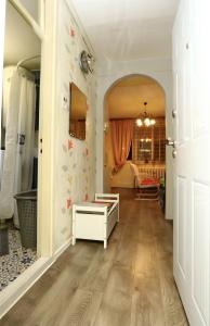 a hallway with a white room with a table at DARA Apatman in Šabac