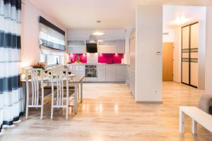 eine Küche und ein Esszimmer mit einem Tisch und Stühlen in der Unterkunft SAS Apartamenty Perfect in Stettin