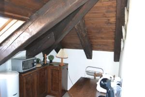 een kamer met houten plafonds en een bureau met een magnetron bij La Dimora della Luna Appartamento Rosso in Trieste