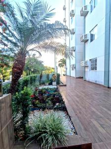 a courtyard with a palm tree in a building at Quarto no centro de Foz do Iguaçu in Foz do Iguaçu