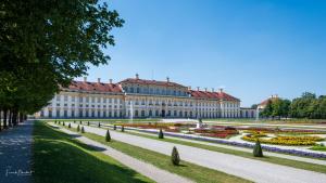 a large building with a garden in front of it at Studio 3 - Apartments am Schloss in Oberschleißheim