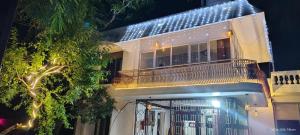 a building with a balcony with lights on it at VR Jardin Resort in Pondicherry