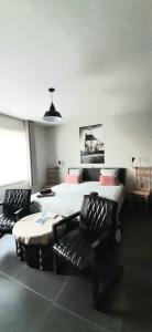 una camera con due letti e due sedie in esso di B & B Victors Hof, met zwemvijver en leuke diertjes a Lievegem