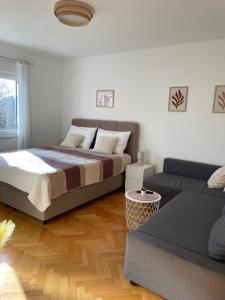 una camera da letto con un letto grande e un divano di Apartment Beauty a Pola (Pula)