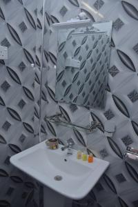 a bathroom with a white sink and a mirror at Coco Villa Udawalawe in Udawalawe