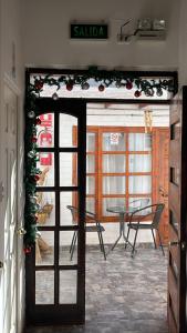 an open door to a patio with a table at Hostal Malú in San Pedro de Atacama