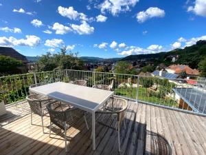 a white table and chairs on a deck with a view at kremsoase in Krems an der Donau