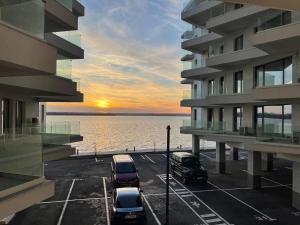 een parkeerplaats met auto's geparkeerd voor een gebouw bij Ianmamaia in Mamaia