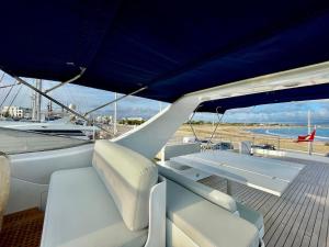 een boot met witte stoelen en een blauw dak bij Mimou Accommodation breakfast on yacht in Yasmine
