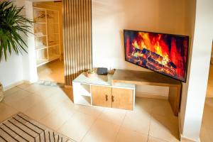 a living room with a flat screen tv on a wall at Umbi Chalet in Dahab