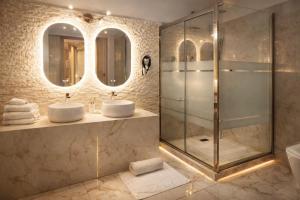 a bathroom with two sinks and a shower at Barberini Dream in Rome