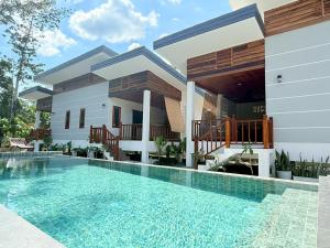 a house with a swimming pool in front of it at BuaSawan Villa Koh Lanta in Ban Not (1)