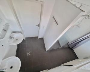 a bathroom with two sinks and a mirror at Haus an der Brücke in Munich +84 photos