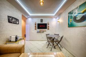 a waiting room with a table and a tv at Appartement saada Agadir in Agadir