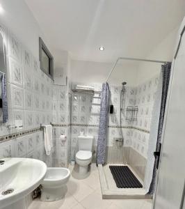 a bathroom with a shower and a toilet and a sink at Spacious apartment in Tétouan