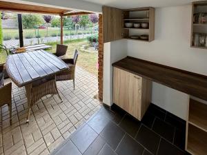 a kitchen and dining area with a table and chairs at Rekreační dům Dobšín in Dobšín