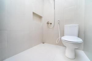 a white bathroom with a toilet and a shower at Semenrante Living By ARBA in Solo +37 photos