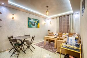 a living room with a couch and a table at Appartement saada Agadir in Agadir