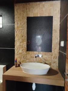 a bathroom with a large white sink on a counter at Sarvesh Arundekar Home Stay In Beach Side AC Room in Gokarna