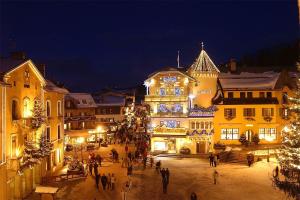 un gruppo di persone che camminano per una città di notte di Melba Megeve emplacement de rêve dans le village au calme a Megève Altre 12 foto