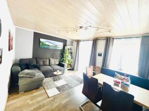 a living room with a couch and a table at Christines Ferienwohnung in Weiler-Simmerberg