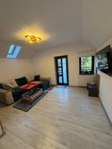 a living room with a couch and a table at Casa Criss in Sinaia
