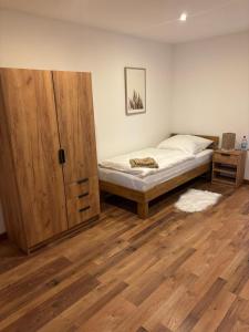 a bedroom with a bed and a wooden door at Schildetal Apartment 1 in Camin