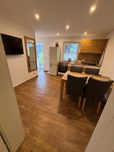 a kitchen with a table and chairs and a refrigerator at Schildetal Apartment 1 in Camin