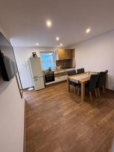 a kitchen and dining room with a table and chairs at Schildetal Apartment 1 in Camin
