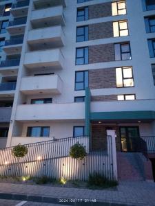 a tall building with a fence in front of it at Gloria Golden Suite- Luxury&Designe Experience in Oradea