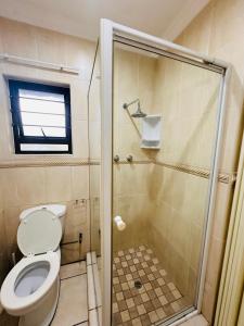 a bathroom with a toilet and a shower at Sanlou - Southport in Port Shepstone +44 photos