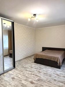 a bedroom with a bed and a mirror in it at Будинок в Мукачево in Mukacheve +14 photos