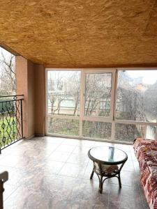 a living room with a couch and a glass table at Будинок в Мукачево in Mukacheve