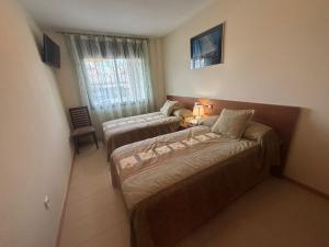 En eller flere senge i et værelse på Apartamento cerca de la playa