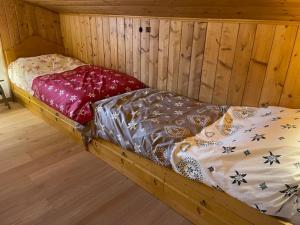 a wooden bed in a wooden room with avertisement at Chalet Luxury Pelmo in San Vito di Cadore