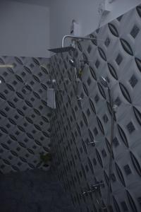 a shower in a bathroom with a tile wall at Coco Villa Udawalawe in Udawalawe +36 photos