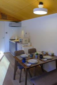 a kitchen with a wooden table with plates on it at 雪箱神楽 in Yuzawa