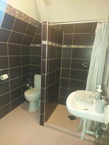 a bathroom with a toilet and a sink at Siófok 7 Apartmanház in Siófok +47 photos