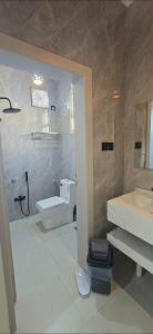 a bathroom with a toilet and a sink at شقق النزهة الفندقيه in Riyadh Al Khabra +17 photos