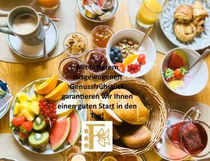 a table with a bunch of breakfast foods and drinks at Frankenhof in Scharnitz