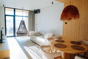a living room with a table and a couch at Calm Luxury Chalet Natural Apartments in Bukovel